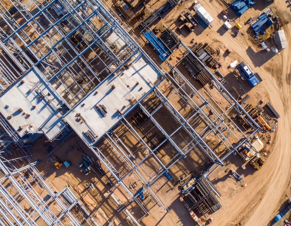 Firefly_-Top-down aerial view of a massive construction site with an industrial steel frame m 108264